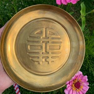 Brass dish with symbol